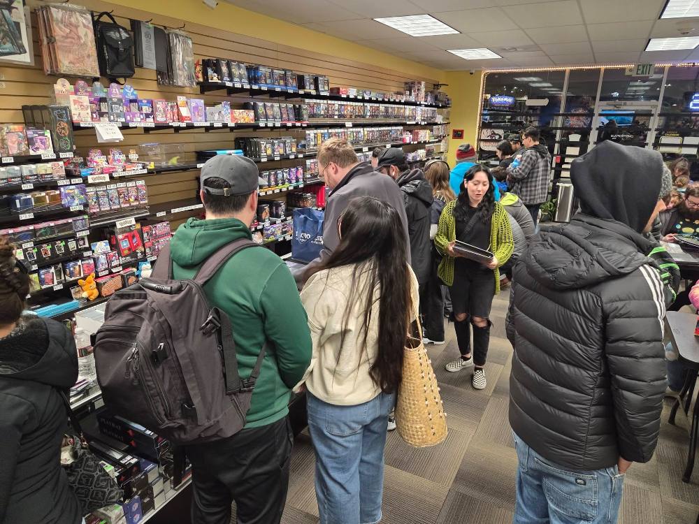 A crowd of collectors packing the shop for a trade night at Cardtropolis TCG
